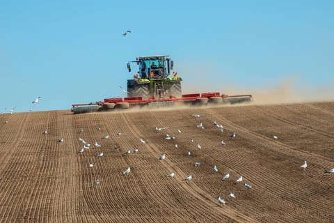 Tractor with rollers preparing the ground for spring sowing at Krageholm, Ystad Municipality, Skåne