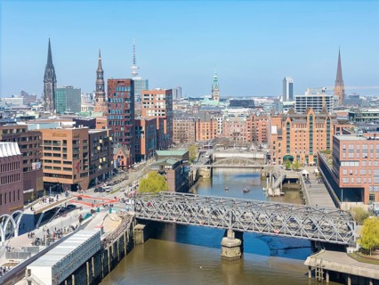 Aerial view of Hamburg's HafenCity with a view of Magdeburg harbour under a clear blue sky,