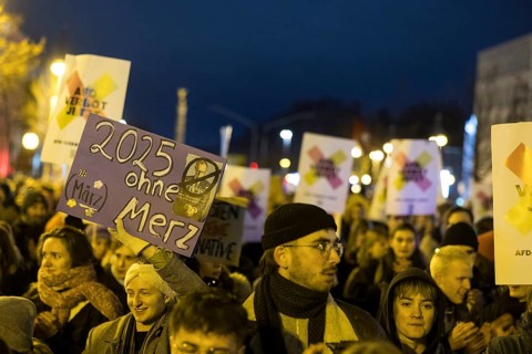 Participants with signs 2025 without Merz and AfD ban now at the demonstration under the slogan