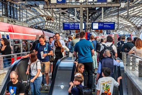 Cologne Central Station. Stairs to the platforms. Travellers waiting for their train on the