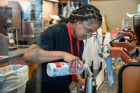 Detroit, Michigan - A young worker at a Starbucks coffee shop at Detroit Metro Airport