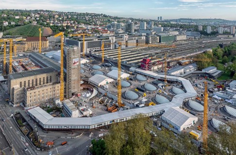 Stuttgart main station with Bonatzbau. Stuttgart 21 construction site with station tower and crane.