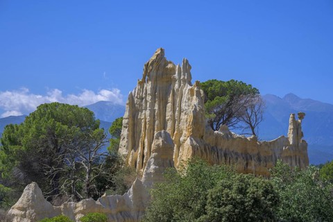 Sandstone cliff Les Orgues with Mount Canigou in the background, Ille-sur-Têt, Centre Ville