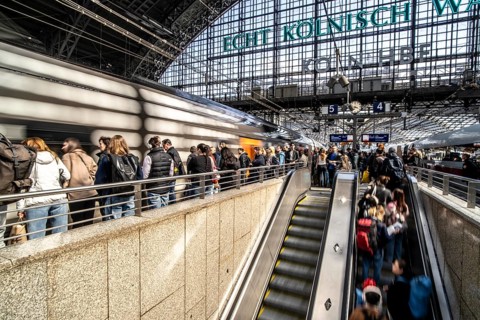Cologne Central Station, escalators to and from the platform, passengers waiting for the train,
