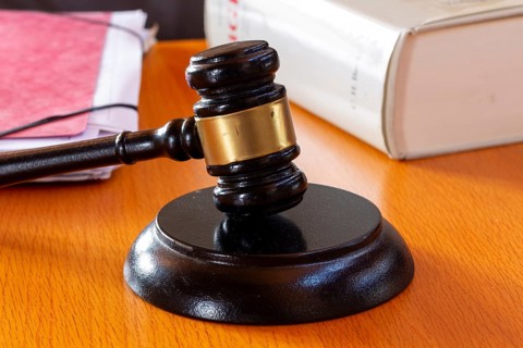 Symbolic image of a court hearing: close-up of a judge's gavel