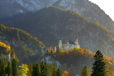 Neuschwanstein Castle in the evening sun, surrounded by impressive natural scenery, Neuschwanstein,