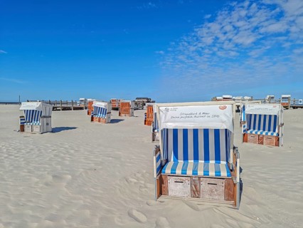 Preparing for the high season on the beach, setting up the beach chairs, North Sea, on the edge of
