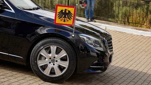 Black limousine with German flag parked outside, visit of Federal President Frank-Walter Steinmeier