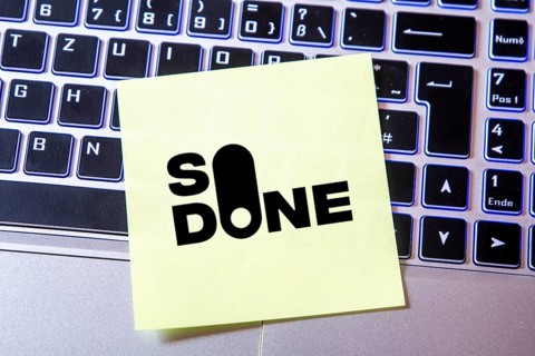 Notepad with the SO DONE logo on a laptop (composing) . SO DONE is a reporting portal specialising