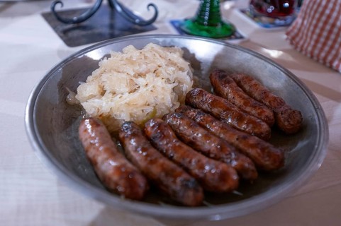 Nuremberg sausages with sauerkraut served on a pewter plate, Nuremberg, Middle Franconia, Bavaria,