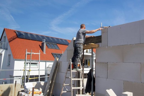 Bricklayer works on a new detached house