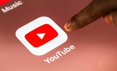 In this photo Illustration a person taps Googles Youtube application on a tablet device on 24 May