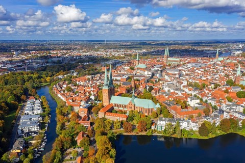 Aerial view over the river Trave and church towers in the old town of the Hanseatic City of Lübeck