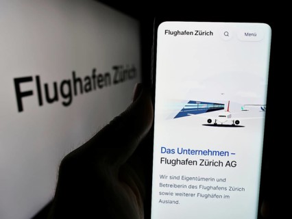 Stuttgart, Germany, 05-31-2024: Person holding smartphone with website of Swiss airport operator