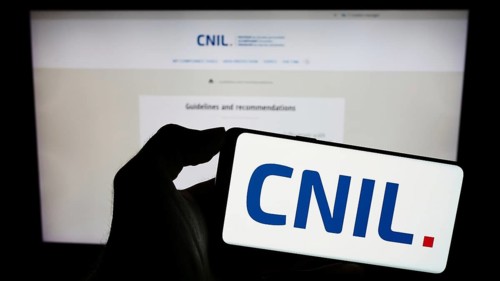 Stuttgart, Germany, 11-21-2023: Person holding mobile phone with logo of Commission Nationale de