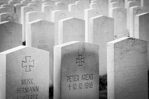 A black and white photo of a First World War military cemetery with rows of gravestones and