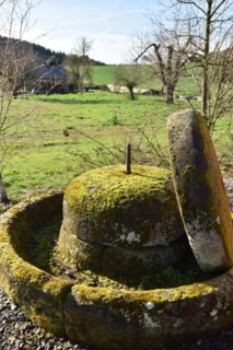 Old millstones in the national park community of Weiden near the Hunsrück-Hochwald National Park in