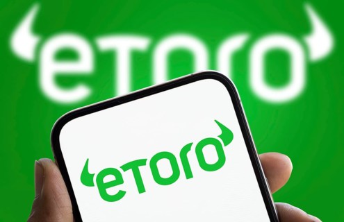 etoro logo is displayed on smartphone. eToro is a social trading and multi-asset investment company