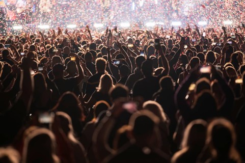 Crowd of people in front of the stage during the concert.
