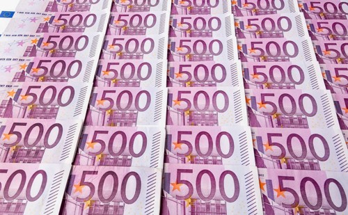 Many five hundred euro banknotes lying next to each other. Symbolic photo for wealth and investment