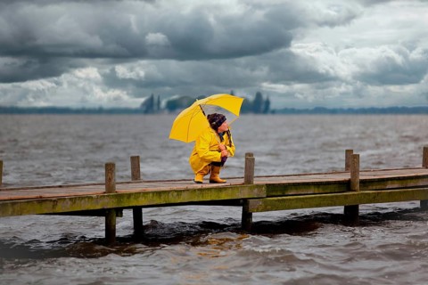 Young woman on a jetty waiting for better weather, Steinhuder Meer, Wunstorf, Lower Saxony, Germany