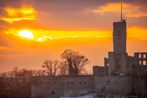 Königstein castle ruins at sunset. Viewpoint with a view over a village to a ruin in winter.