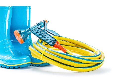 Garden tools rubber boots hose nad sprayer gun isolated