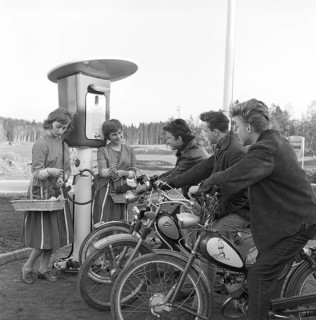 Teenagers of the 1950s. Three teenage boys at the petrol station that is being opened for the first