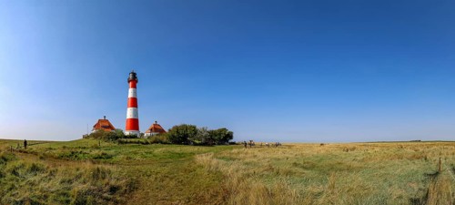 Panoramic photo 40 metre high Westerheversand lighthouse built in 1906 on the Eiderstedt peninsula