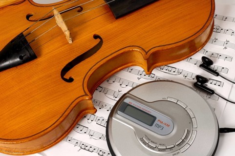 CD-player and a violin on sheet music