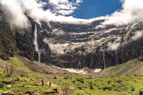 Hikers in the cloudy Cirque de Gavarnie basin, UNESCO World Heritage Site in the Pyrenees National