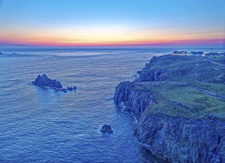 Land's End, coast and hotel on the Atlantic, at dusk. Land's End, the tip of the headland in the