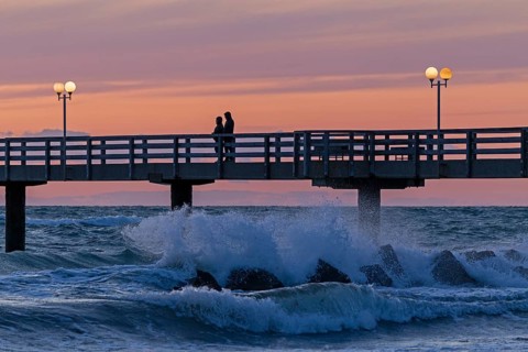 Sunset, pier, people, silhouettes, waves, swell, spray, street lamps, Wustrow, Fischland,