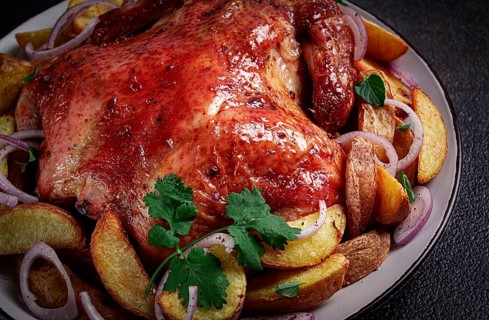 Fried, baked chicken, in the oven, with spices, and rustic potatoes, top view, homemade