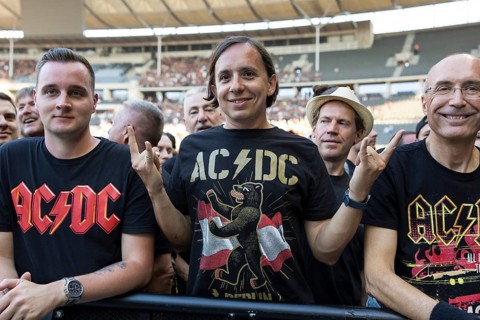 Fan in the front row with AC/DC Berlin shirt in front of the concert of AC/DC live on Power Up Tour
