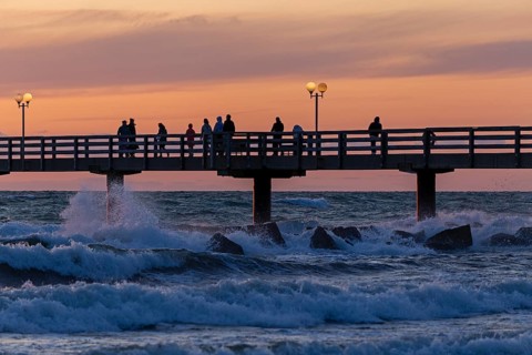 Sunset, pier, people, silhouettes, waves, swell, spray, street lamps, Wustrow, Fischland,