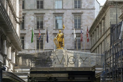 Count Peter of Savoy golden figure above entrance to The Savoy hotel, Strand, central London,