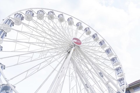 Beautiful Ferris wheel with illuminated gondolas in front of a clear sky, Ferris wheel