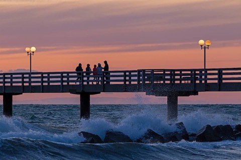 Sunset, pier, people, silhouettes, waves, swell, spray, street lamps, Wustrow, Fischland,