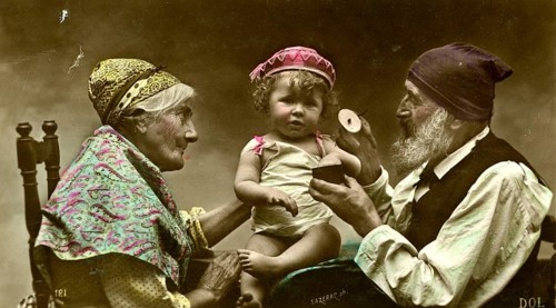 Grandma and grandpa with grandson, 1910, A baby is lovingly held by his grandparents, surrounded by