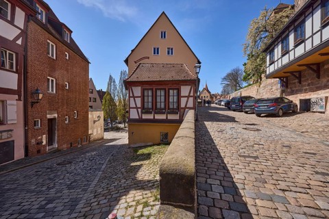 Residential building, historic half-timbered houses, sandstone wall, lantern, cobblestones, trees,