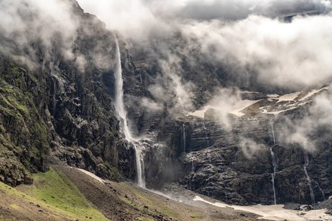 Waterfall in the cloudy Cirque de Gavarnie basin, UNESCO World Heritage Site in the Pyrenees