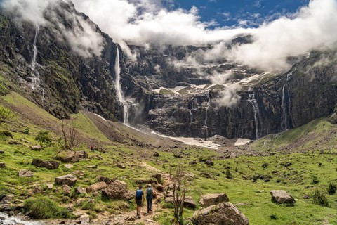 Hikers in the cloudy Cirque de Gavarnie basin, UNESCO World Heritage Site in the Pyrenees National