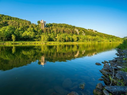 Prunn Castle on a steep cliff above the Altmühl Valley in the evening light, reflection in the