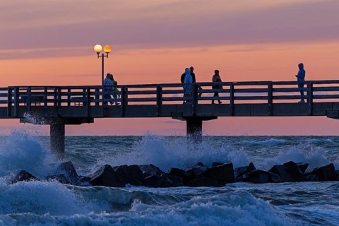 Sunset, pier, people, silhouettes, waves, swell, spray, street lamps, Wustrow, Fischland,