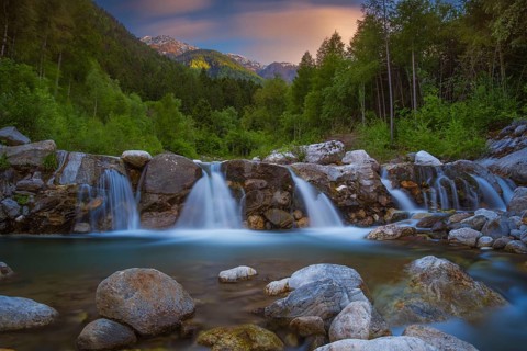 View of a waterfall of the Rio Plima stream in the evening light, long exposure, landscape photo,