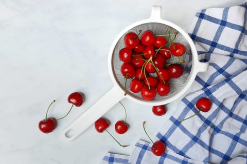 Sweet cherries in sieve, Prunus avium, bird cherry