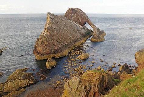 Impressive coastal view of a rock formation reaching far into the sea, Bow Fiddle Rock,
