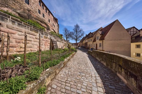 Old town, historic buildings, castle wall, sandstone wall, footpath, cobblestones, trees, garden,