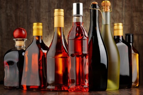 Composition with bottles of assorted alcoholic beverages